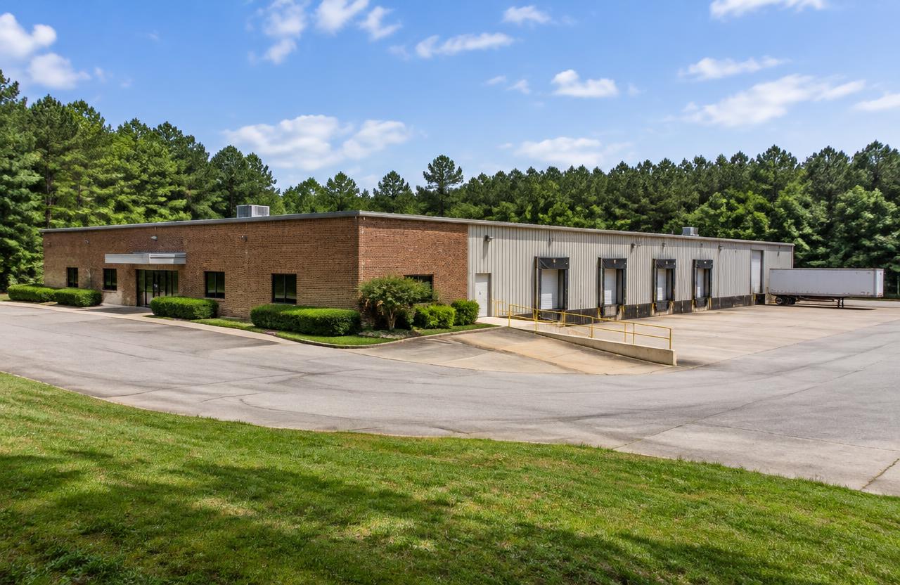 Warehouse with loading facilities — AI-generated property illustration, not a verified local property